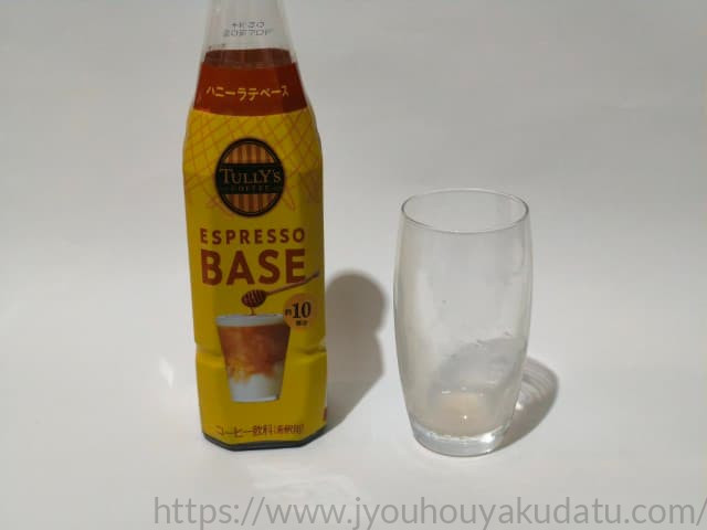 飲み終わった空のグラスとタリーズ ハニーラテベースのボトル
